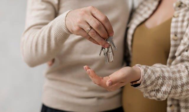 A man handing house keys to his wife.