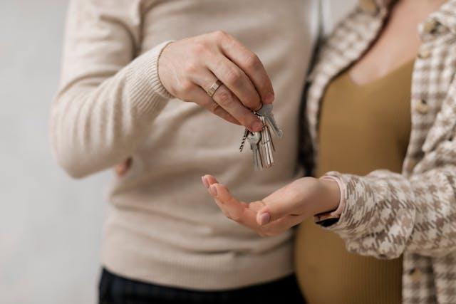 A man handing house keys to his wife.